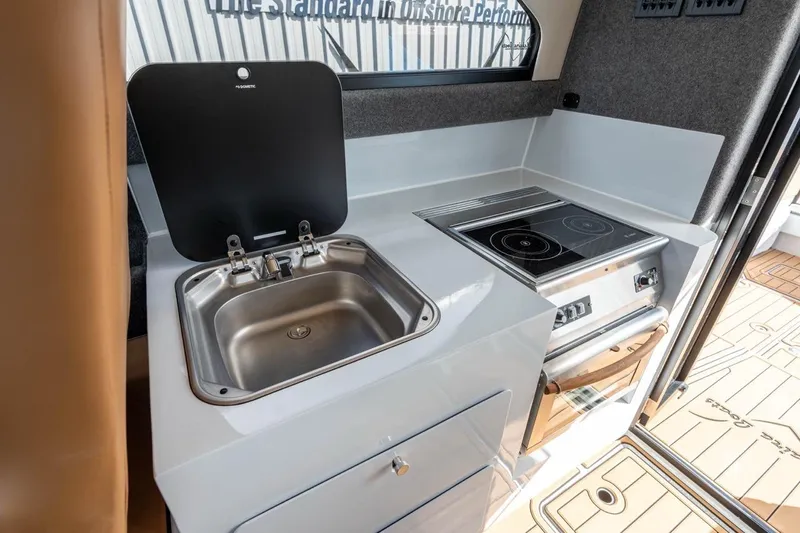 Slide: The Image of Compact kitchen in 2025 Makaira Gen 3 36 boat with sink and stove. - 9