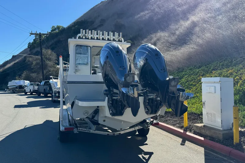 Slide: The Image of 2026 Defiance Admiral 250 EX boat with dual outboard motors on a trailer. - 11