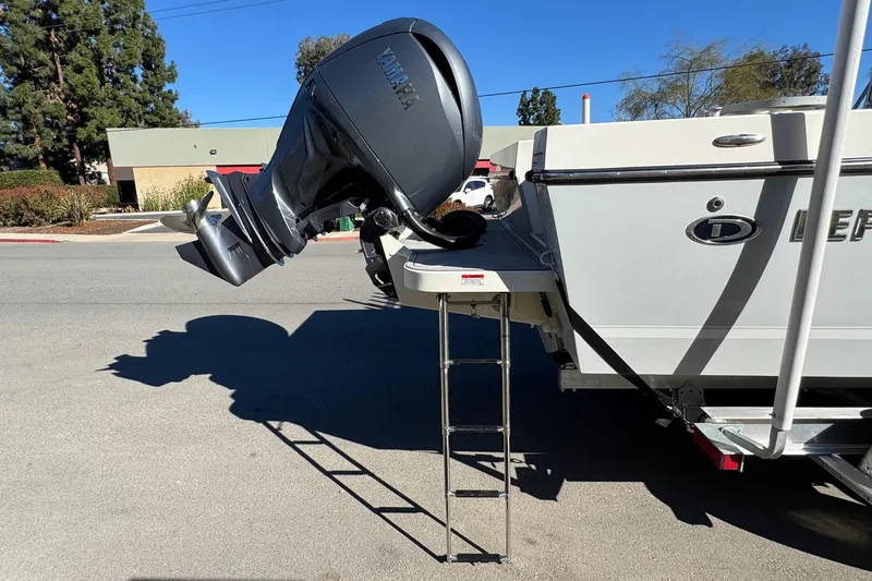 Slide: The Image of 2026 Defiance Admiral 250 EX boat with Yamaha outboard motor and ladder on a sunny day. - 22