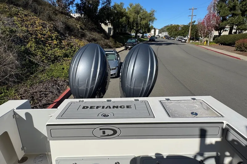 Slide: The Image of 2026 Defiance Admiral 250 EX boat with dual engines on a street. - 28