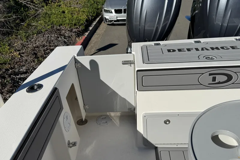 Slide: The Image of 2026 Defiance Admiral 250 EX boat deck with dual engines and storage compartments. - 29