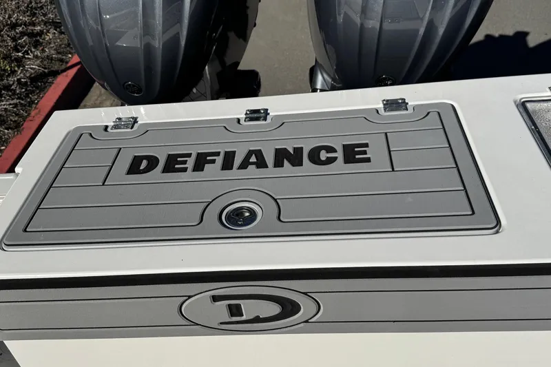 Slide: The Image of 2026 Defiance Admiral 250 EX boat deck with logo and storage compartment. - 31