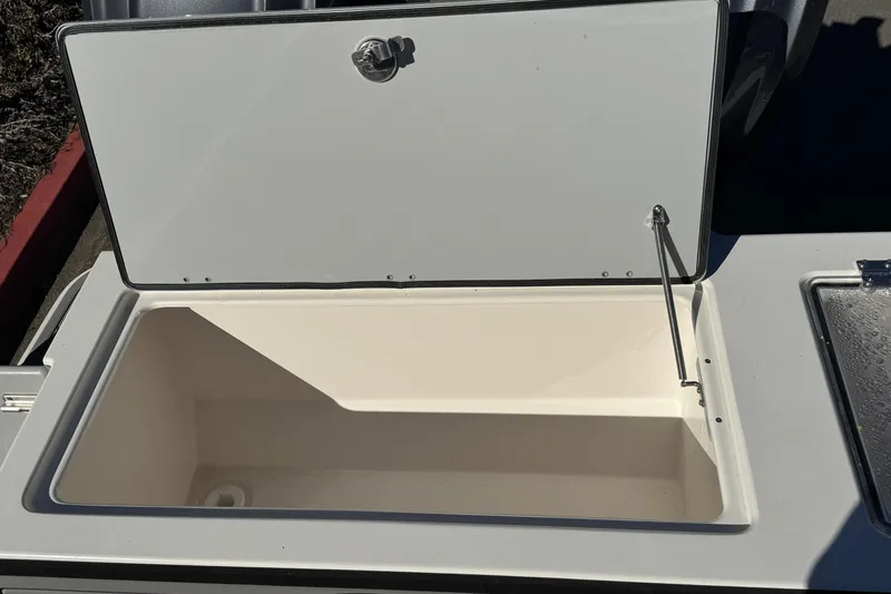 Slide: The Image of Open storage compartment on 2026 Defiance Admiral 250 EX boat. - 32