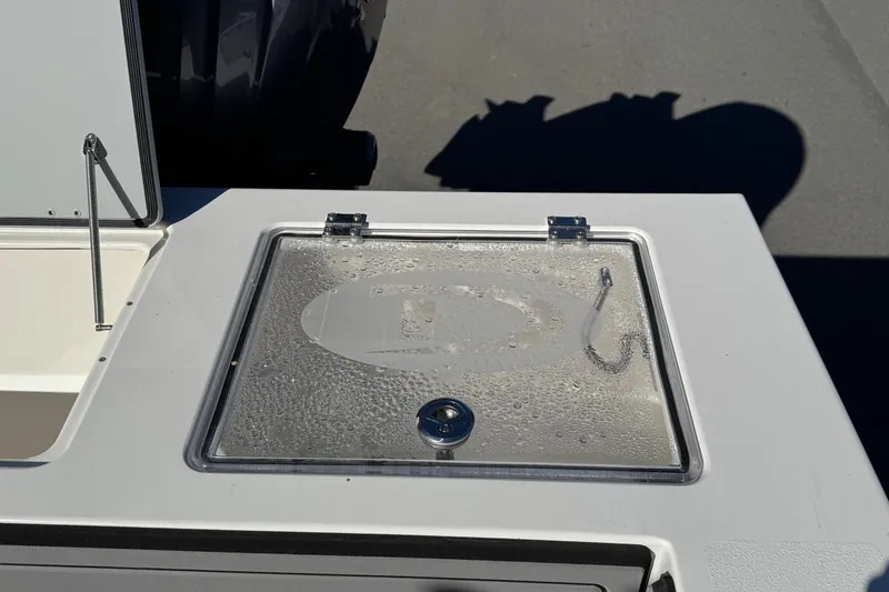 Slide: The Image of 2026 Defiance Admiral 250 EX boat deck with wet storage compartment. - 33