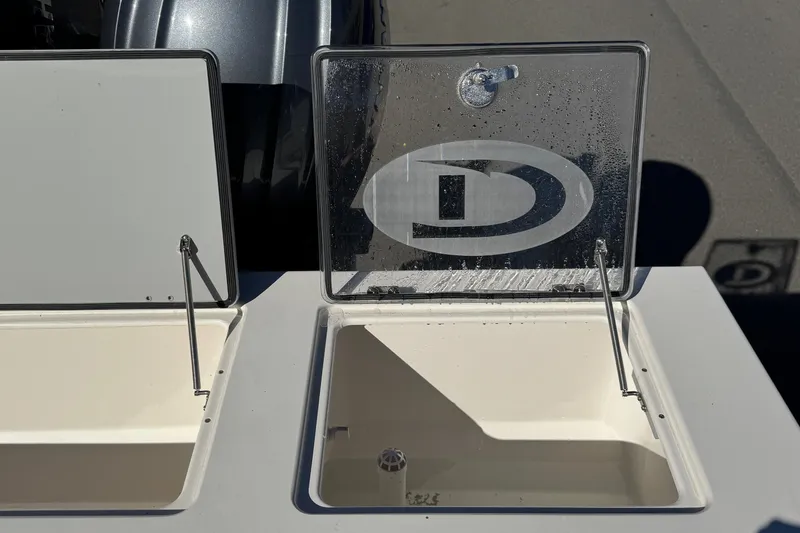 Slide: The Image of Open compartments on a 2026 Defiance Admiral 250 EX boat, showcasing storage space. - 34