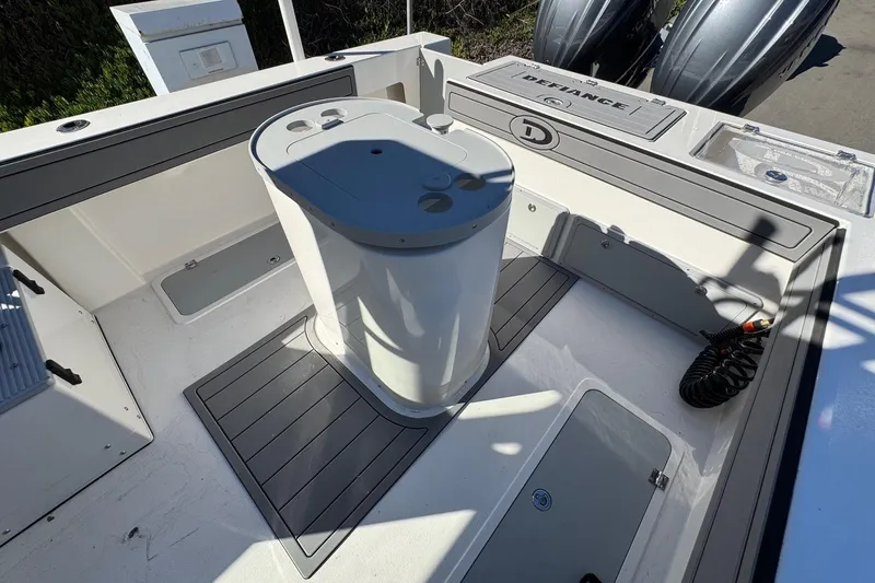 Slide: The Image of 2026 Defiance Admiral 250 EX boat deck with storage compartments and seating area. - 35