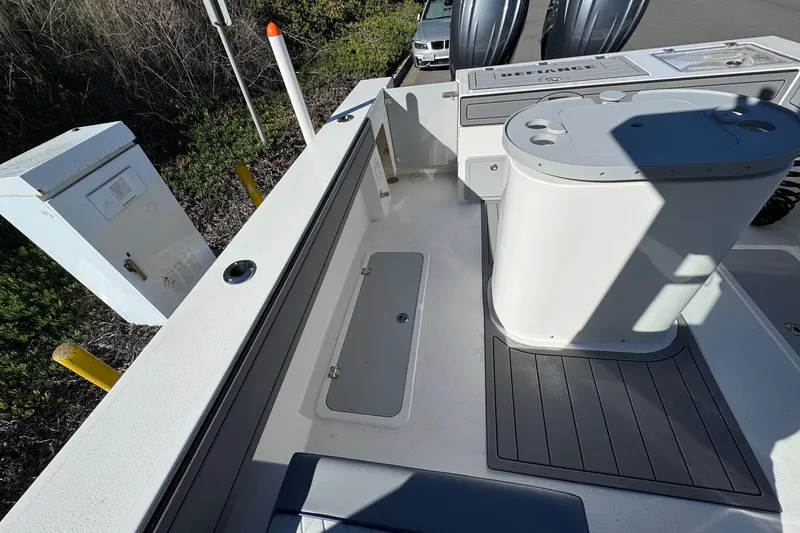 Slide: The Image of 2026 Defiance Admiral 250 EX boat deck with storage compartments and seating area. - 37