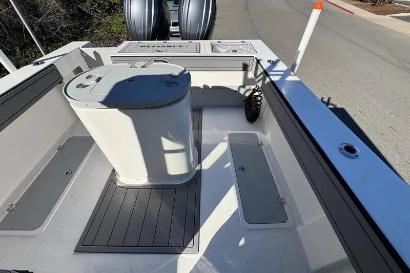 Slide: The Image of 2026 Defiance Admiral 250 EX boat interior with storage compartments and seating area. - 38