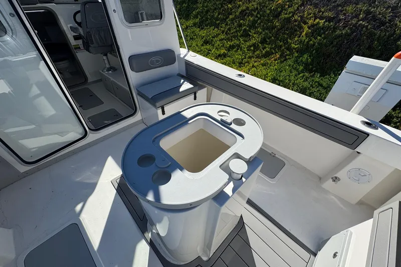 Slide: The Image of 2026 Defiance Admiral 250 EX boat interior with seating and storage compartments. - 42