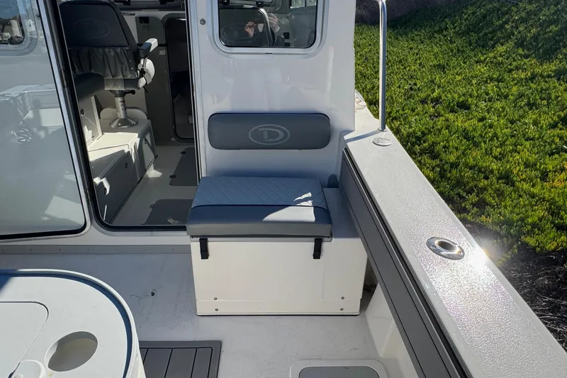 Slide: The Image of 2026 Defiance Admiral 250 EX boat interior with seating and helm station. - 45
