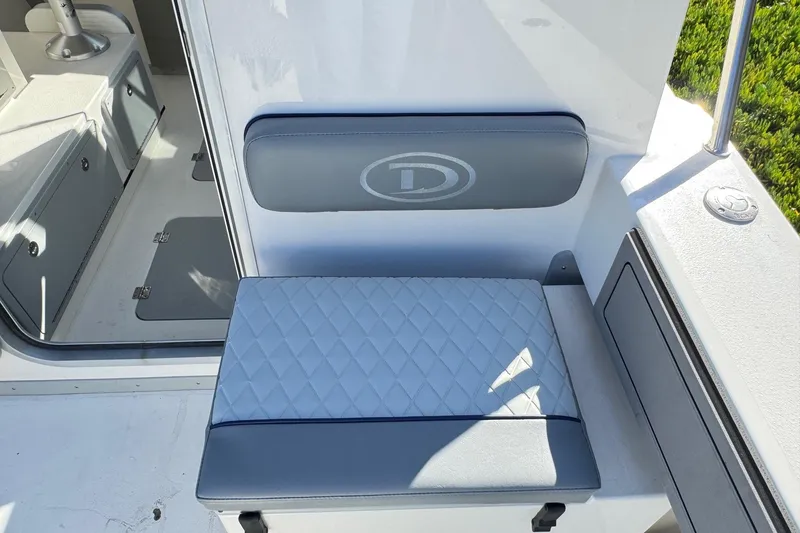 Slide: The Image of 2026 Defiance Admiral 250 EX boat interior with cushioned seating and storage compartments. - 46