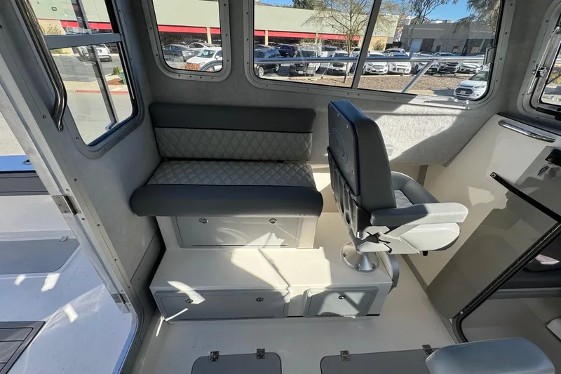 Slide: The Image of Interior of 2026 Defiance Admiral 250 EX boat with seating and windows. - 51