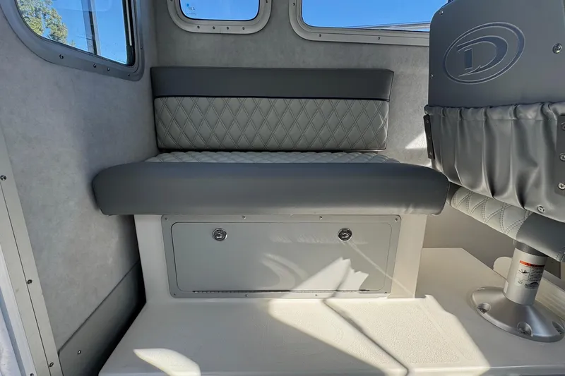Slide: The Image of Interior seating of 2026 Defiance Admiral 250 EX boat, featuring quilted upholstery. - 52