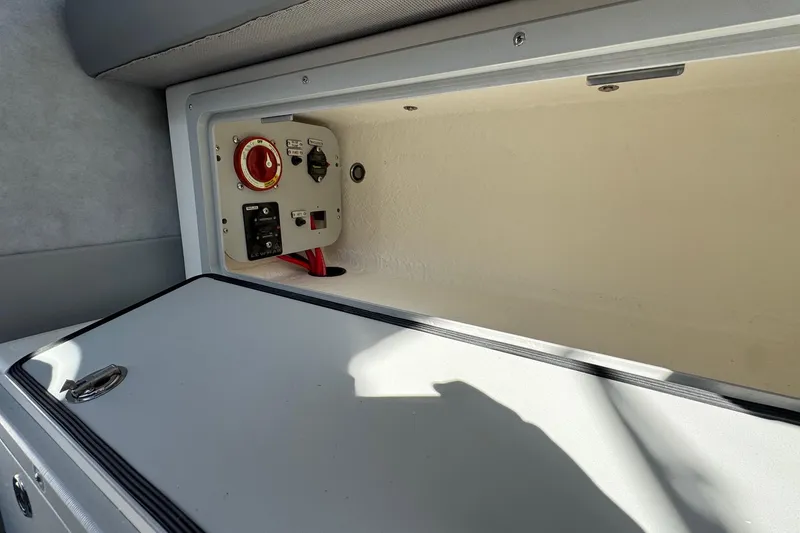 Slide: The Image of 2026 Defiance Admiral 250 EX boat storage compartment with control panel and wiring. - 54