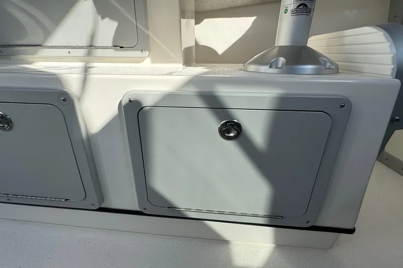 Slide: The Image of Storage compartments on a 2026 Defiance Admiral 250 EX boat, featuring sleek design and secure latches. - 59