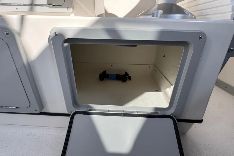 Slide: The Image of Open storage compartment on 2026 Defiance Admiral 250 EX boat. - 60