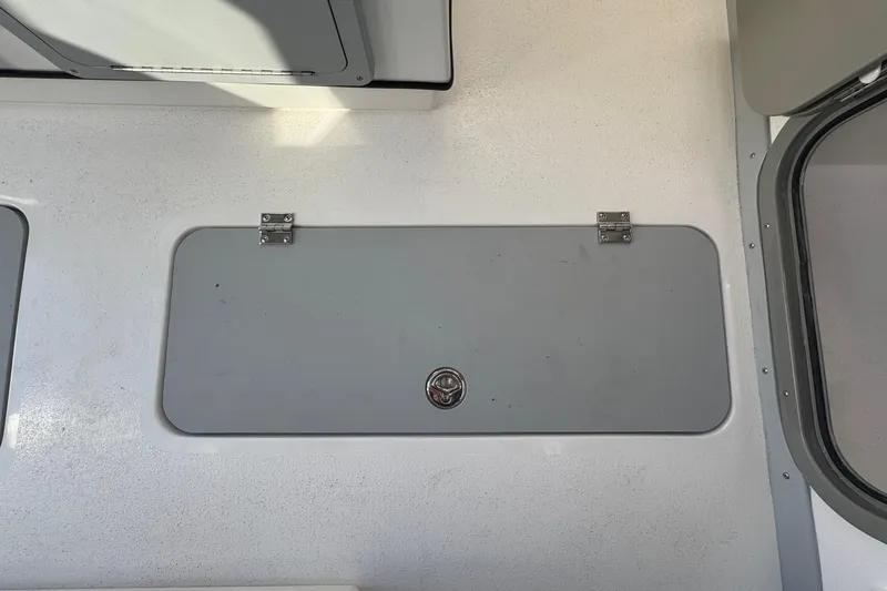 Slide: The Image of Hatch on 2026 Defiance Admiral 250 EX boat deck, featuring secure latch and hinges. - 61