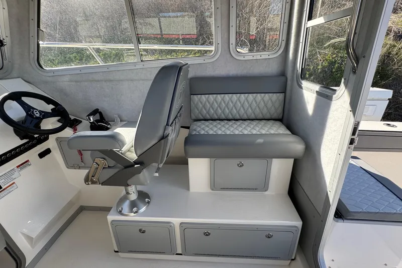 Slide: The Image of Interior of 2026 Defiance Admiral 250 EX boat with seating and steering wheel. - 63