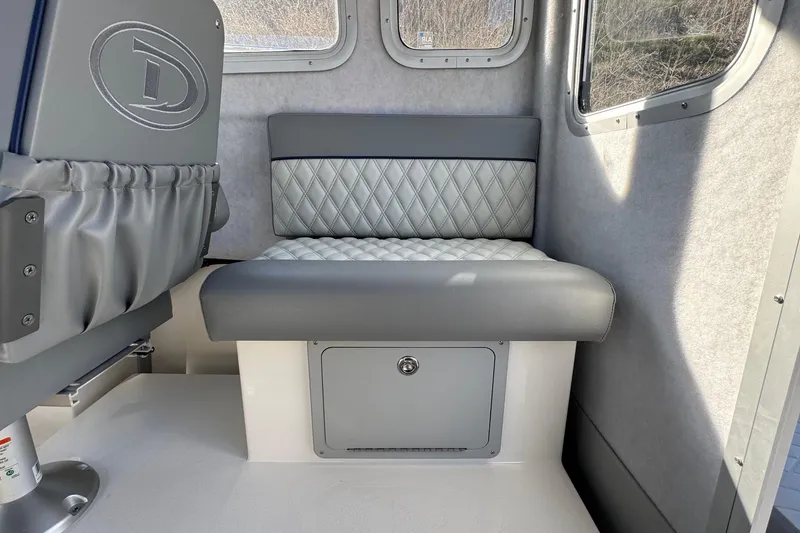 Slide: The Image of Interior seating of 2026 Defiance Admiral 250 EX boat, featuring quilted upholstery. - 64