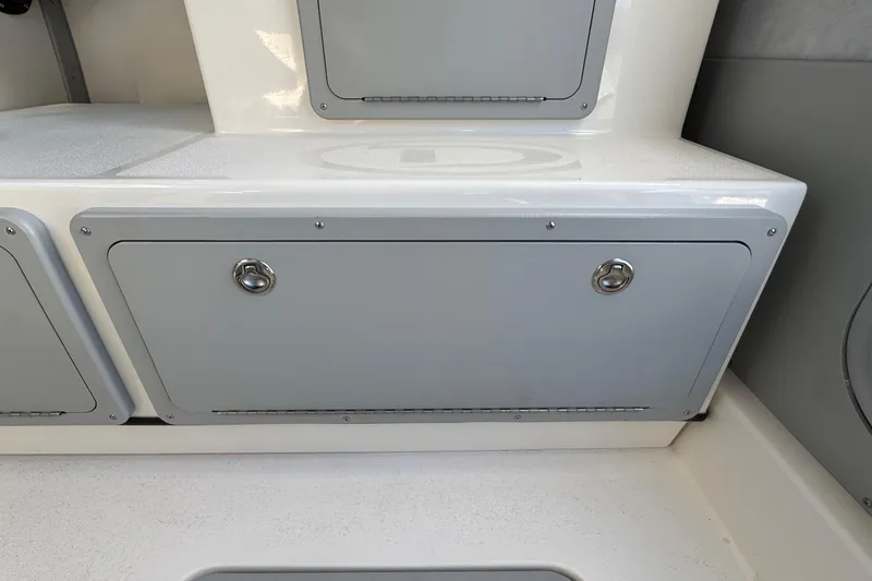 Slide: The Image of 2026 Defiance Admiral 250 EX boat storage compartment with sleek design and secure latches. - 66