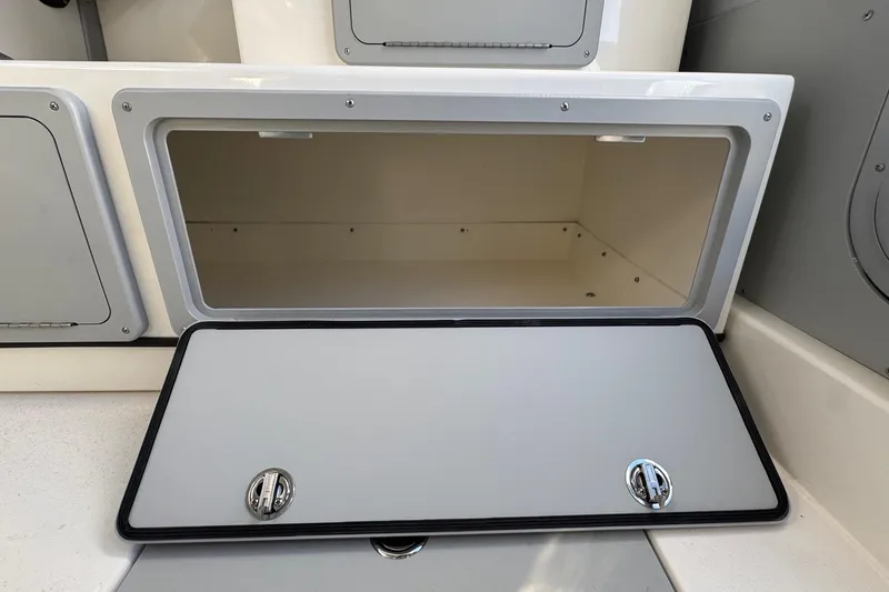 Slide: The Image of Open storage compartment on 2026 Defiance Admiral 250 EX boat. - 67