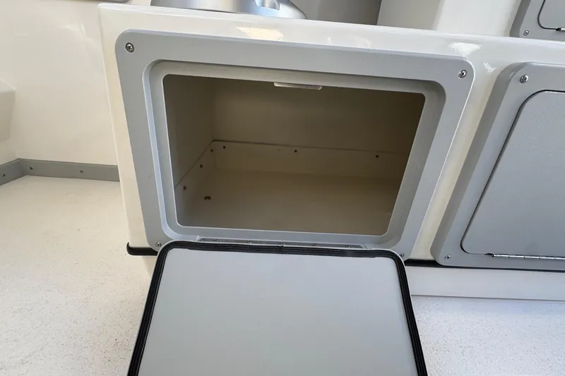 Slide: The Image of Open storage compartment on 2026 Defiance Admiral 250 EX boat. - 69