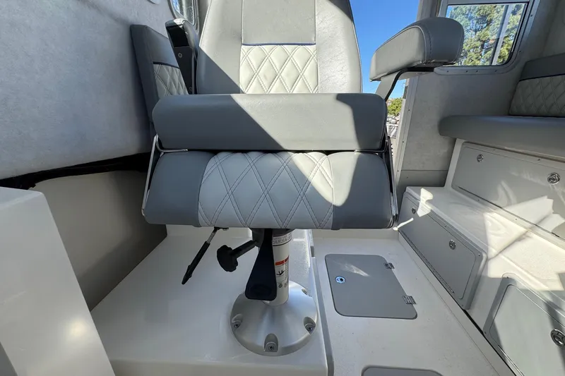 Slide: The Image of Captain's chair in 2026 Defiance Admiral 250 EX boat interior. - 74