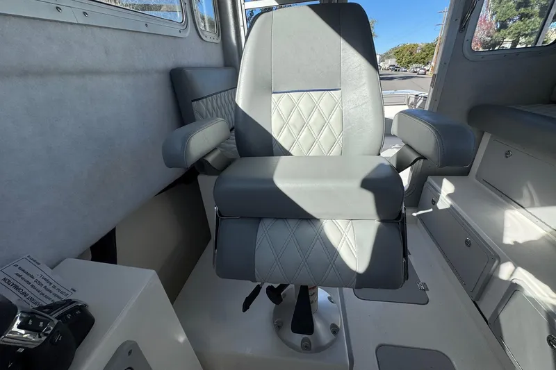 Slide: The Image of Captain's chair in 2026 Defiance Admiral 250 EX boat interior. - 75