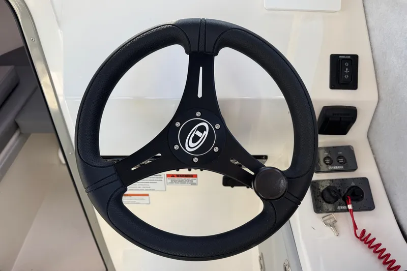 Slide: The Image of Steering wheel of 2026 Defiance Admiral 250 EX boat with control panel. - 81