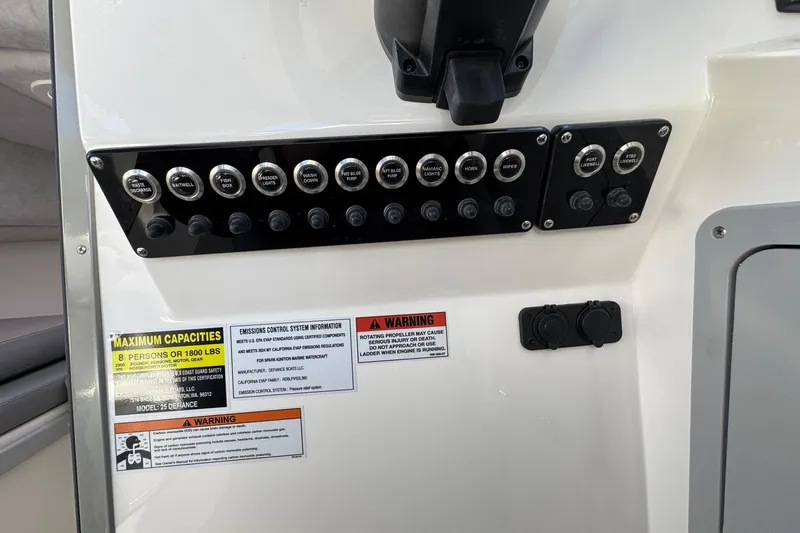 Slide: The Image of Control panel of 2026 Defiance Admiral 250 EX boat with capacity and warning labels. - 83