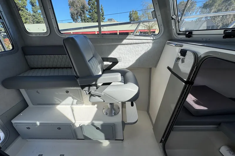 Slide: The Image of Interior of 2026 Defiance Admiral 250 EX boat with seating and storage compartments. - 84