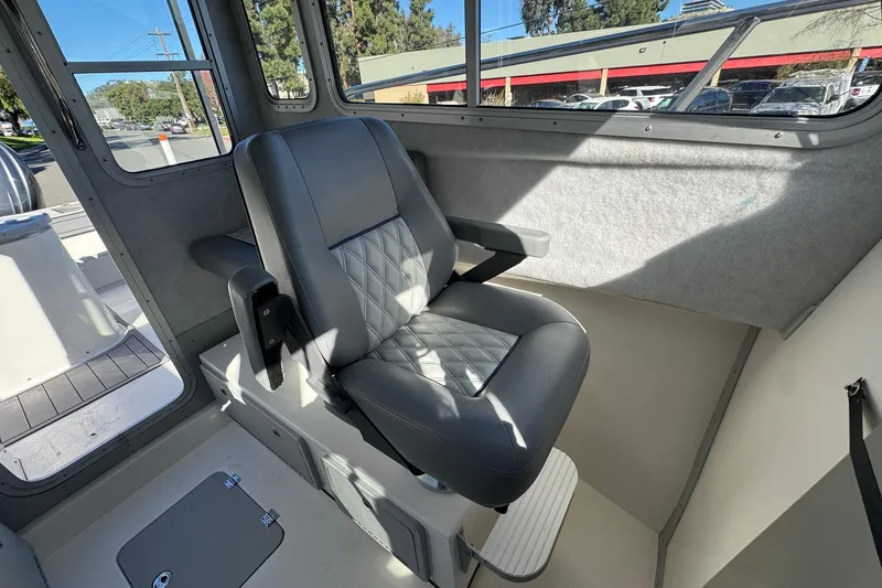 Slide: The Image of Interior of 2026 Defiance Admiral 250 EX boat with a cushioned captain's chair. - 86