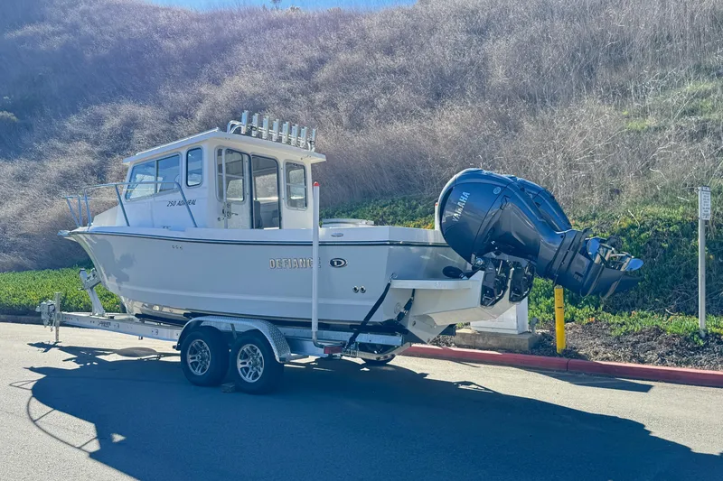 Slide: The Image of 2026 Defiance Admiral 250 EX boat on trailer with Yamaha outboard motor. - 9