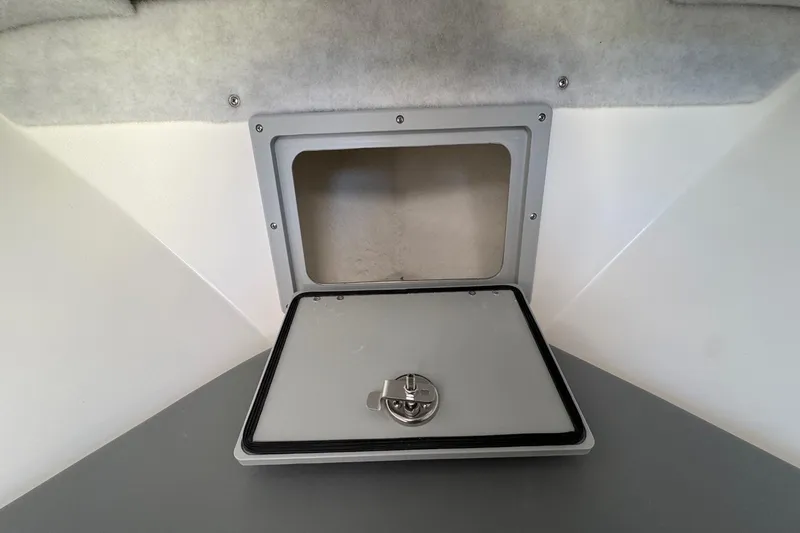 Slide: The Image of Hatch door of 2026 Defiance Admiral 250 EX boat, open with visible latch. - 95