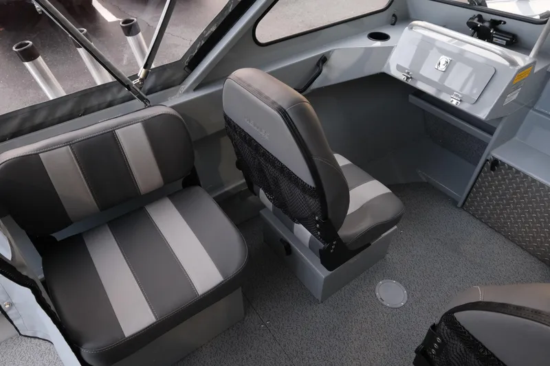Slide: The Image of 2026 Hewescraft 180 Sportsman interior with gray seating and storage compartments. - 10