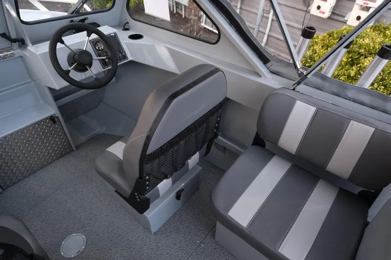 Slide: The Image of 2026 Hewescraft 180 Sportsman interior with gray seating and steering wheel. - 11