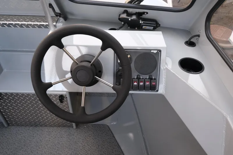Slide: The Image of Steering wheel and control panel of 2026 Hewescraft 180 Sportsman boat interior. - 13