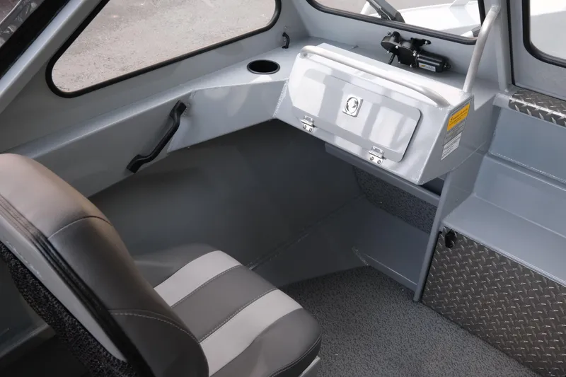 Slide: The Image of 2026 Hewescraft 180 Sportsman interior with gray seating and storage compartment. - 14