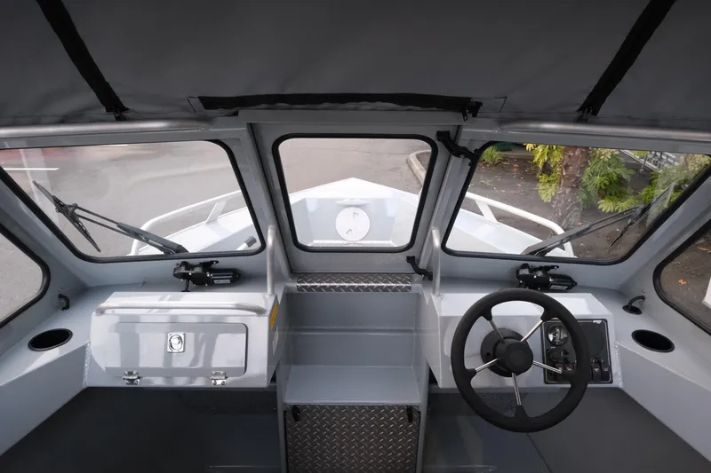 Slide: The Image of 2026 Hewescraft 180 Sportsman boat interior with steering wheel and dashboard view. - 15