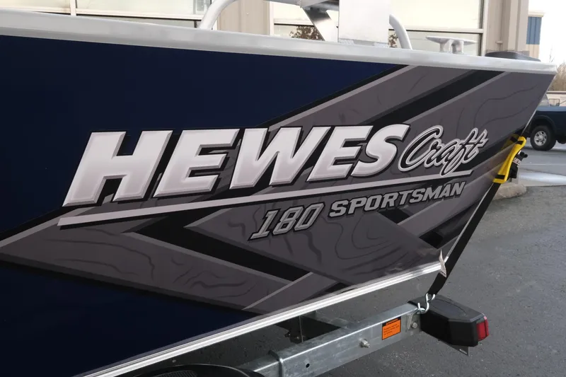 Slide: The Image of 2026 Hewescraft 180 Sportsman boat with bold branding on the side. - 6