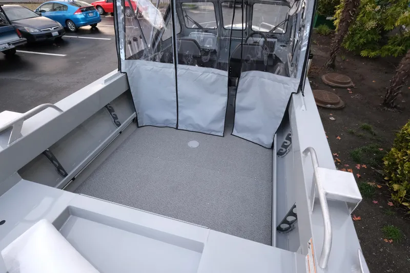Slide: The Image of 2026 Hewescraft 180 Sportsman boat interior with spacious deck and protective canopy. - 7
