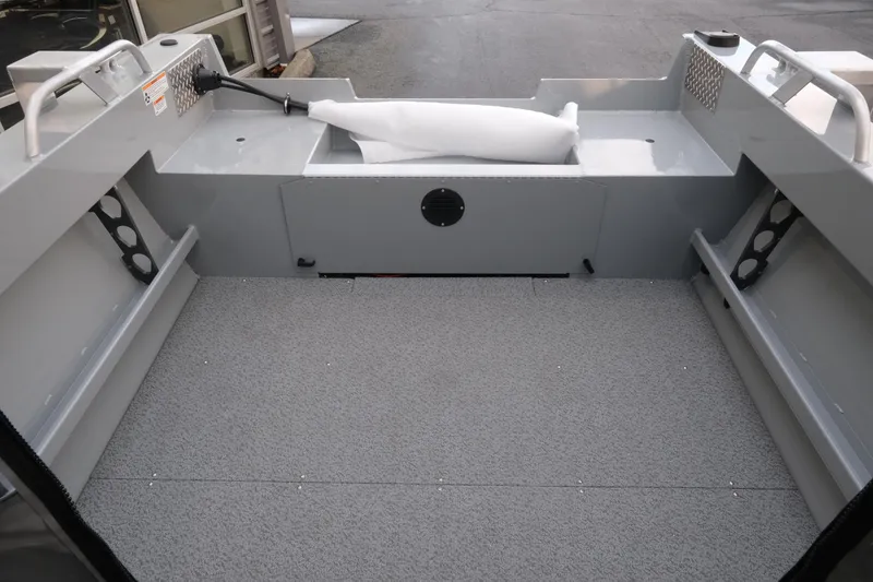 Slide: The Image of 2026 Hewescraft 180 Sportsman boat interior with spacious deck and storage compartments. - 8