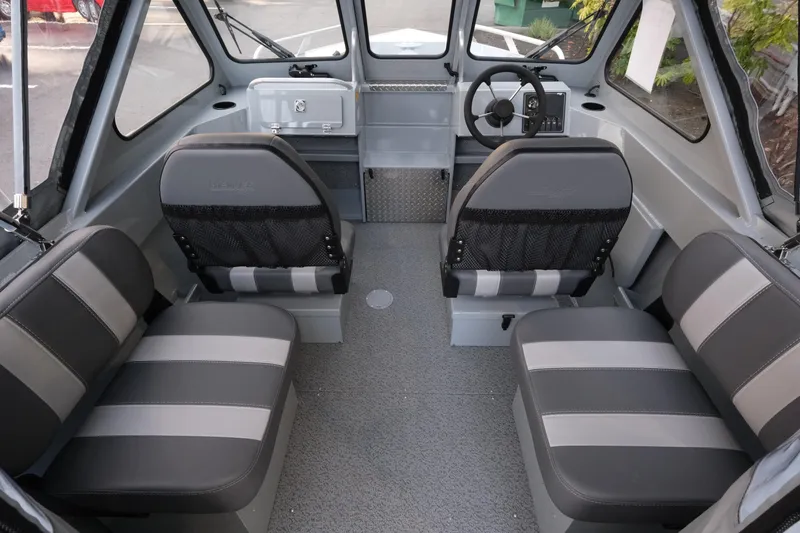 Slide: The Image of Interior of 2026 Hewescraft 180 Sportsman boat with gray seating and steering console. - 9