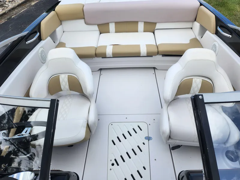 Slide: The Image of 2016 Glastron GT 205 boat interior with beige and white seating. - 21