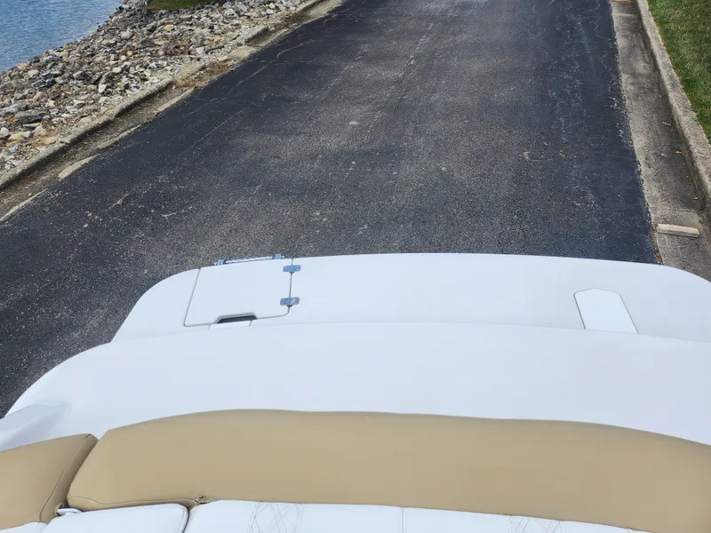 Slide: The Image of 2016 Glastron GT 205 boat on a paved ramp near rocky shoreline. - 24