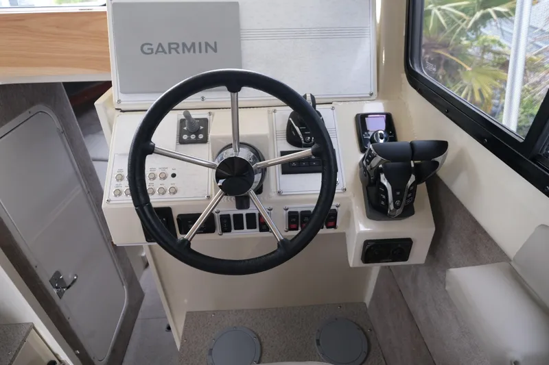Slide: The Image of 2025 Hewescraft 290 Adventure helm with Garmin navigation and modern controls. - 14