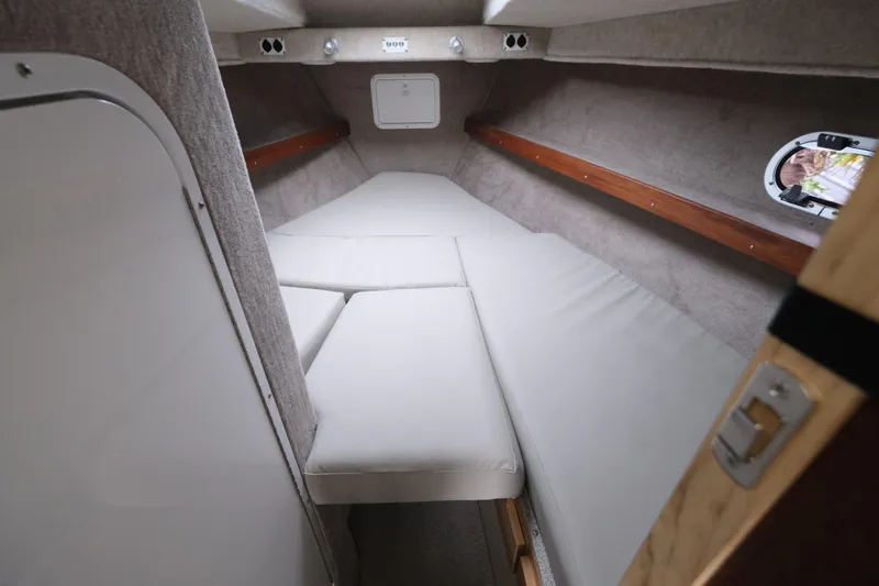 Slide: The Image of 2025 Hewescraft 290 Adventure cabin interior with cushioned sleeping area. - 18