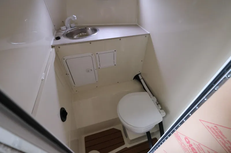 Slide: The Image of Compact bathroom in 2025 Hewescraft 290 Adventure boat, featuring sink and toilet. - 19