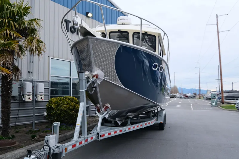 Slide: The Image of 2025 Hewescraft 290 Adventure boat on trailer outside a building. - 3