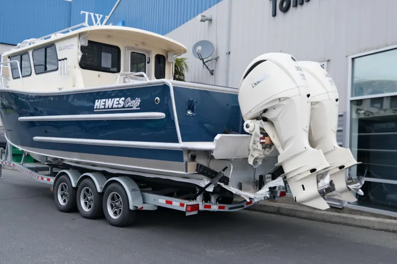 Slide: The Image of 2025 Hewescraft 290 Adventure boat on trailer with dual outboard engines. - 4